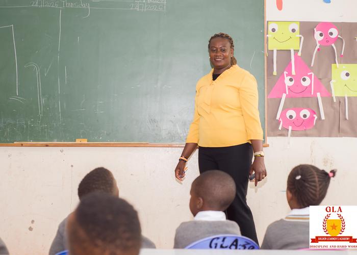 Primary teacher leading a lesson at the chalkboard